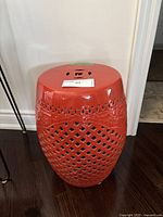 Full view of the stool showing shape, color, top surface, and base