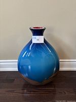 Front view of a 20-inch blue decorative glass vase with copper base, showing overall shape and color.