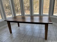 Full view of table in front of bay window showing overall condition and design