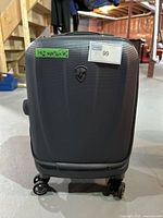 Front view of gray Heys suitcase with dimensions label and lot number sticker