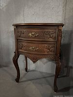 Full front view of side table showing two drawers, carved detail and cabriole legs