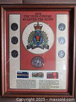 Wood framed display showing coins, stamps, and emblem for 1973 Canada RCMP commemoration