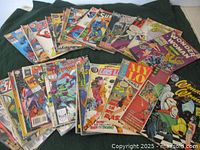 Group of 34 vintage comic books from 1960s-1980s including various superhero titles.