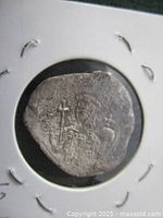 Front side of ancient silver cup coin showing figure of Christ and inscriptions