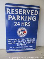 Front view of blue sign showing text, logo and condition