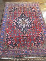 Full front view of rug showing central medallion and field pattern