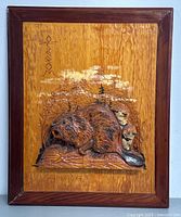 Front view of the framed wooden plaque showing detailed hand carved beaver and natural background.