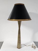 Overall front view of lamp fully assembled on grey surface