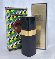 Chanel No. 5, White Diamonds, and Magnum for Men perfume bottles with their boxes.