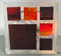 Front view of lamp off, showing colored glass squares within textured clear glass block