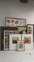 Photo of multiple framed artwork and posters showing vegetable prints, alphabet print, abstract art, and vintage scenes.