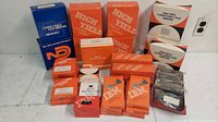 Photo showing lots of IBM branded orange boxes for correctable film ribbons and correction tapes along with some NCR branded blue memory correction tape boxes.