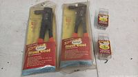 Two new old stock Arrow E-Z Pull Rivet Tools, Model RH200, in original sealed packaging, with two packs of assorted rivets.