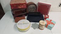 Full lot of assorted tins and gift boxes of varying shapes and designs.