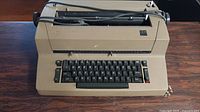 Top angled front view of beige IBM Selectric II typewriter showing keyboard and overall condition.