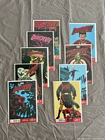 Photo showing a selection of 9 Daredevil comics with various artistic covers including action poses and thematic elements.