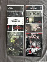 Ten King Spawn comics stacked in two columns, each individually sleeved in protective covers, showing varied cover art with dark and gothic themes.