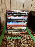 Stack of 15 DVD cases showing spine titles including Glory Road, Flight of Phoenix, Fever Pitch, Enter the Dragon, and others.