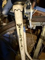 Close-up of bicycle fork showing Flandria logo and emblem on cream colored frame with wear