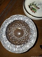 Clear crystal ashtray with starburst textured pattern, viewed from above showing details of cut glass design
