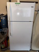 Full view of the Kenmore refrigerator with closed doors, showing white exterior with two-door design (top freezer and bottom fridge).