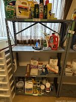 Photo of one of the two metal shelving units loaded with various items.
