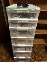 Full view of the plastic organizer unit showing all seven labeled drawers on wheels.
