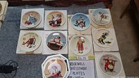 Photo showing 10 Christmas plates in original boxes, each featuring a different Norman Rockwell scene. Plates 8 inches round. Photos highlight arrangement and condition.