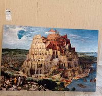 Full view of the art print showing the Tower of Babel with detailed architecture and landscape, placed against a wall.