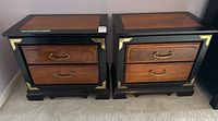Front view of two wooden bed side tables side by side showing drawers and brass handles.