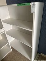 White shelf unit with three shelves shown from front-left angle. Dimensions noted on tape as 36" W x 12" D x 47.5" H. Lightly used condition visible.