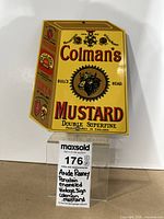 Front view of the yellow enameled vintage Colman's Mustard sign with detailed text and bull graphic.