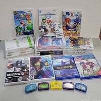 Full assortment of Wii, PS4 and LeapFrog games arranged neatly. Shows front covers of major Wii games, two PS4 game cases and five LeapFrog cartridges in various colors.