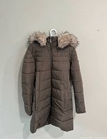 Full front view of DKNY army green quilted coat on hanger
