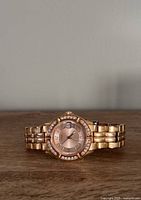 Front view of Guess rose gold watch showing dial, crystal bezel and bracelet
