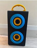 Front view showing dual drivers with blue and yellow accents