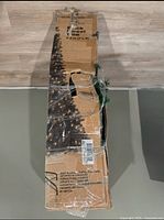 Cardboard box with image of fully assembled Christmas tree