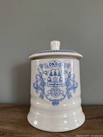 Front view of canister showing crest and shape