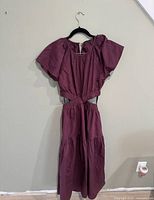 Burgundy cutout midi dress front view on hanger