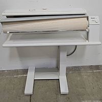 Front view of entire Miele B890 rotary roller iron on its stand showing ironing roller and base