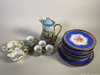Image showing ELW Bavaria cobalt blue floral sandwich/lunch plates stacked with Victoria Austria coffee pot and demitasse cups and saucers arranged beside them.