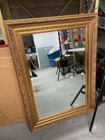 Full view of the large rectangular wall mirror with gilded ornate frame showing overall size and condition.