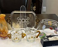 Overview of Murano napkin holder, Waltherglas floral tray, creamer, sugar bowl, Millefiori bottle stopper and Chris Van Zanten signed vase showing lot contents.