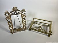 Photo showing both the brass photo frame and the brass adjustable missal/book stand side by side on a white background.