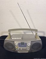 Sony CFD-V17 front view showing speakers, cassette player, CD player lid, control buttons, tuning dials, and telescopic antenna