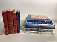 Books grouped in two sets showing spines and titles, includes classic literature and art reference titles