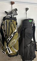 Two golf bags, one Callaway green stand bag and one black carry bag, shown full of clubs