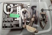 Full view of flaring tools including flaring bar, clamps, Y-shaped flaring tool and accessories, all laid out on a flat surface.