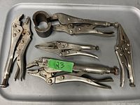 Three different locking pliers (vise grips) showing various sizes and styles including a pipe grip attachment, in used but good condition.