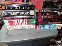 Stack of 7 Stephen King books showing spines and partial front covers, 5 hardcover and 2 softcover editions visible.